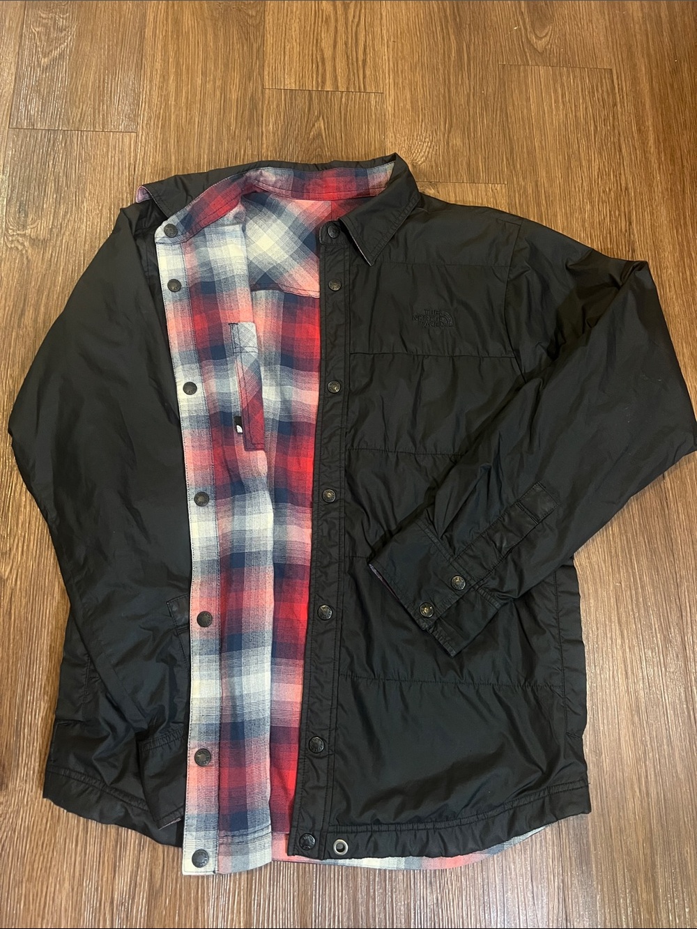 The North Face Black Jacket with Red & Blue Plaid Lining can be worn inside-out